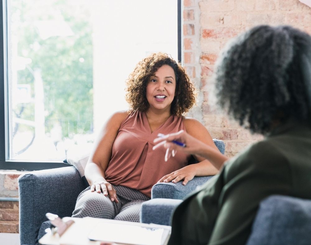 a woman chatting to a psychotherapist