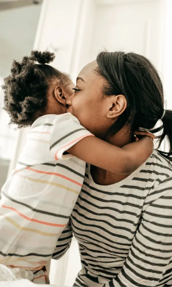 A mother receives a warm hug from her one year old child